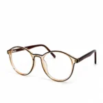 A pair of round, clear peach acetate eyeglasses with dark brown inner rim accents and dark brown temples, displayed on a plain white background.